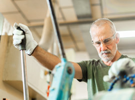 Man of boomer age working with tools