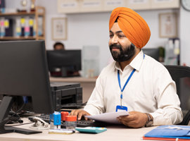 Man in an office working at a computer